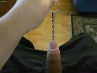 Shocking insertion footage features guy sliding metal object down long penis shaft while hard